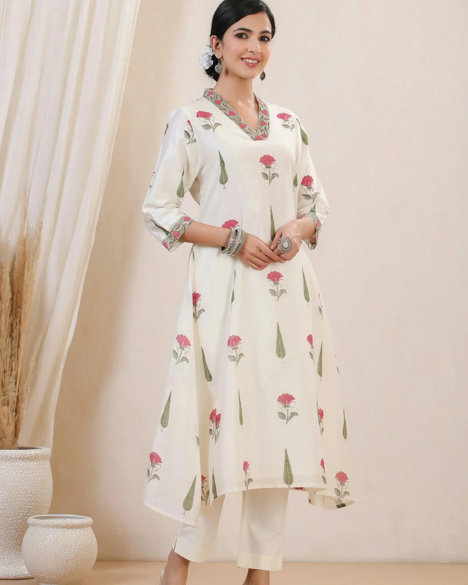 Woman wearing a floral white kurti outfit